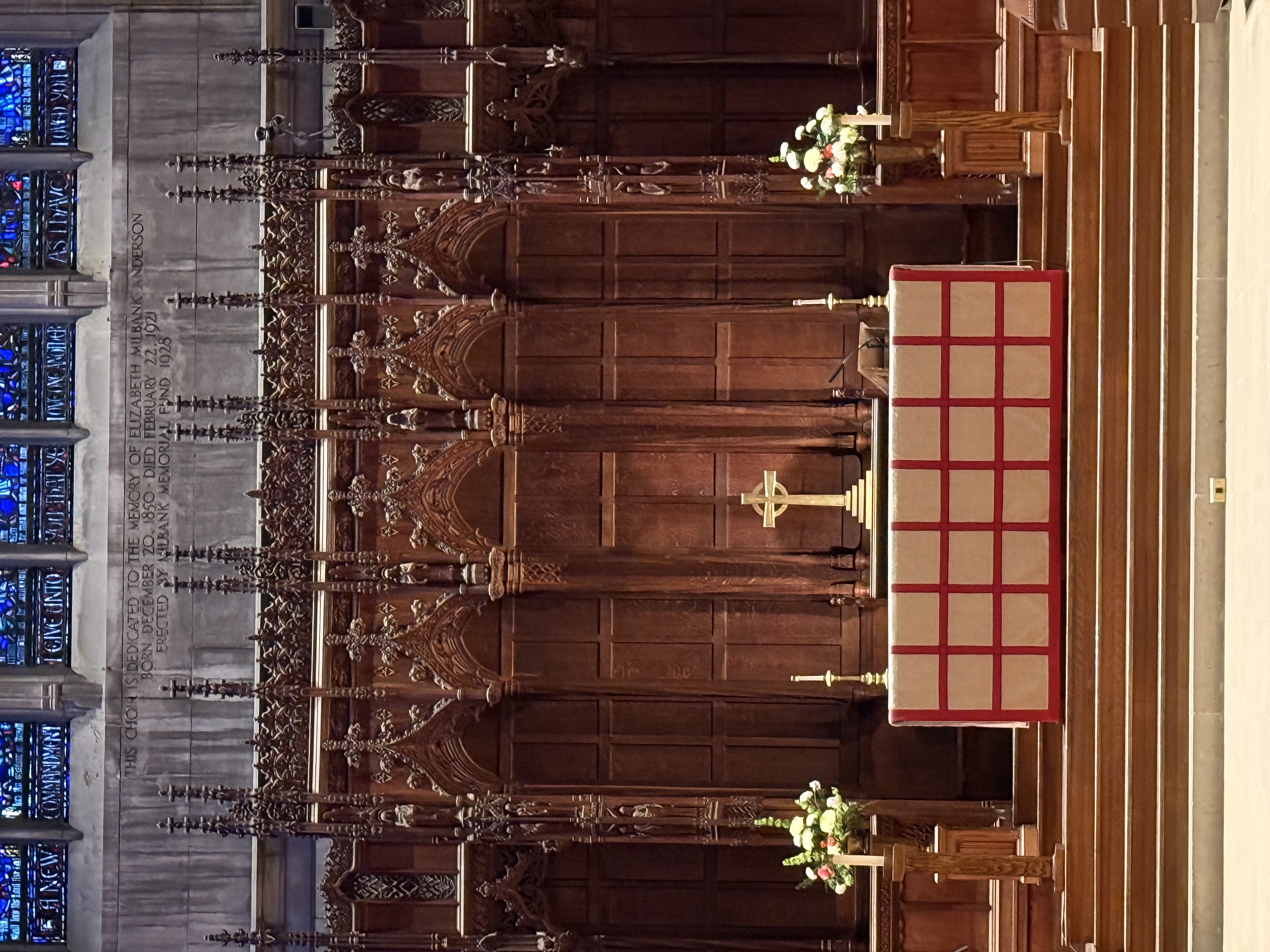Wooden altar screen and steps beneath surrounding chapel arches