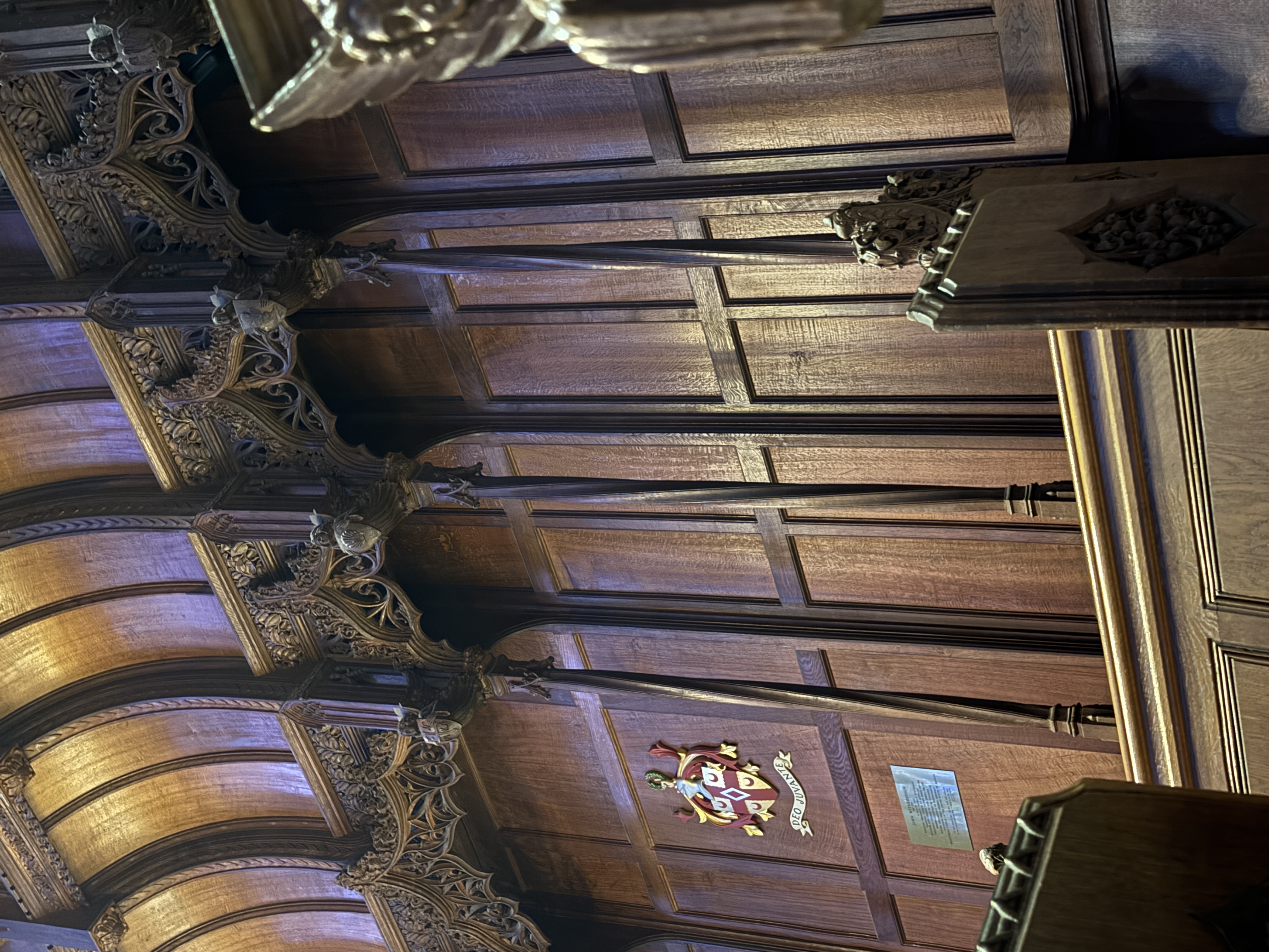 Close view of carved woodwork and arched wall panels inside the chapel