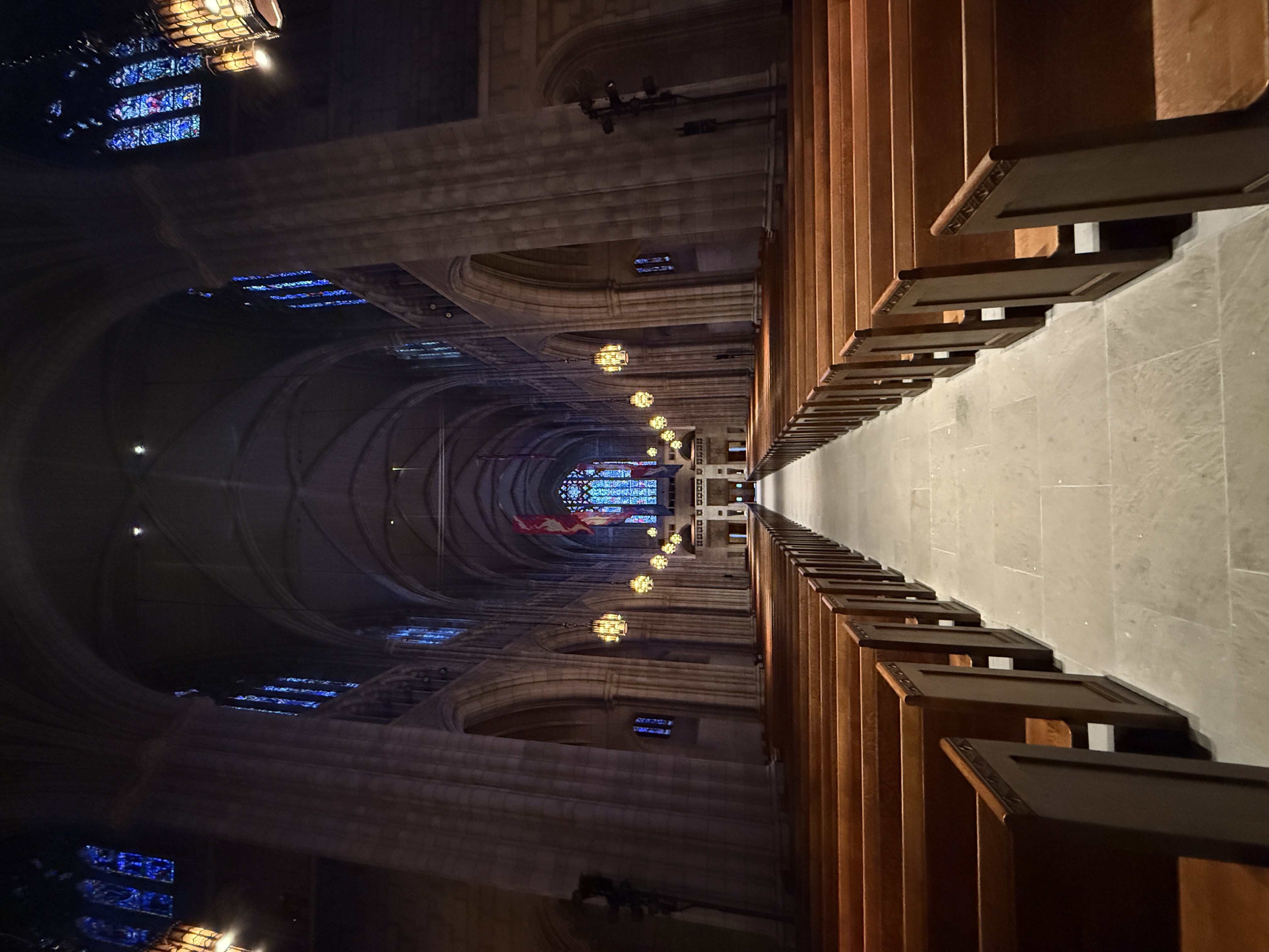 Central aisle lined with pews and flanked by tall pointed arches